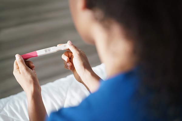 Woman holding a pregnancy test